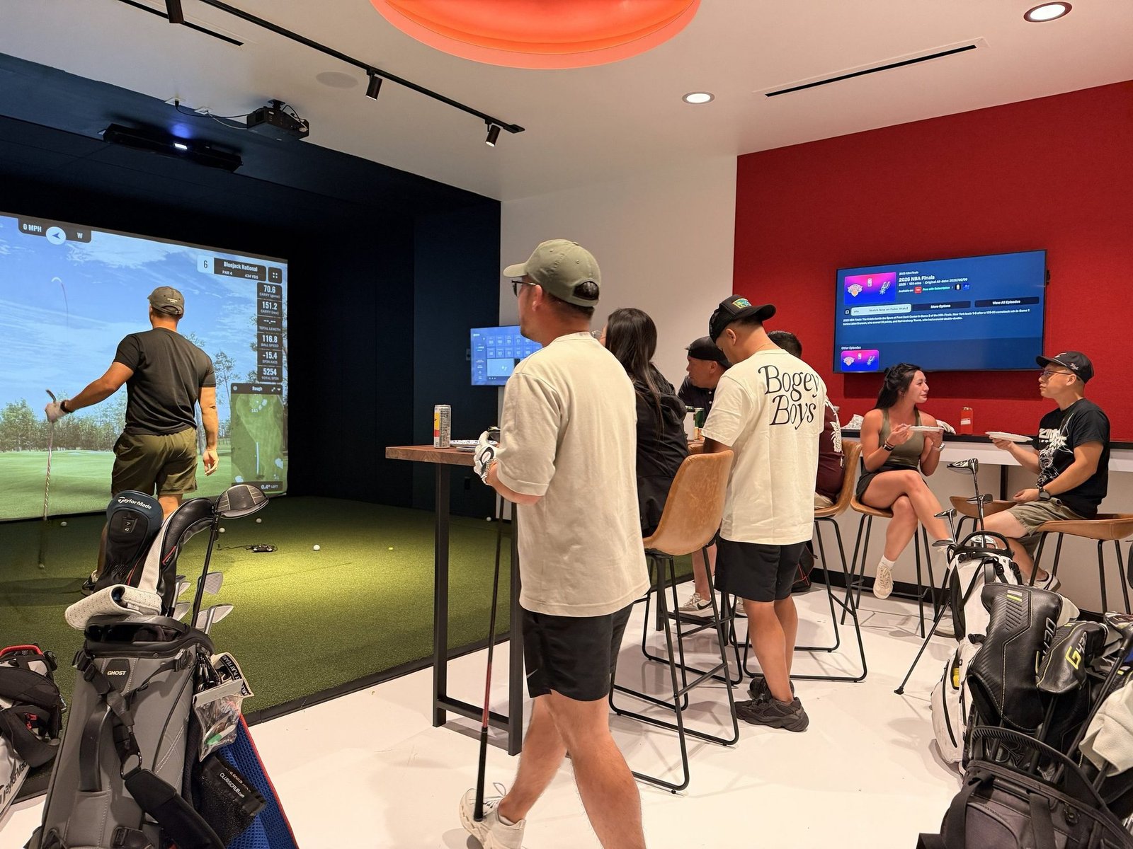Guests playing and socialising in the Birdie Central bays and lounge