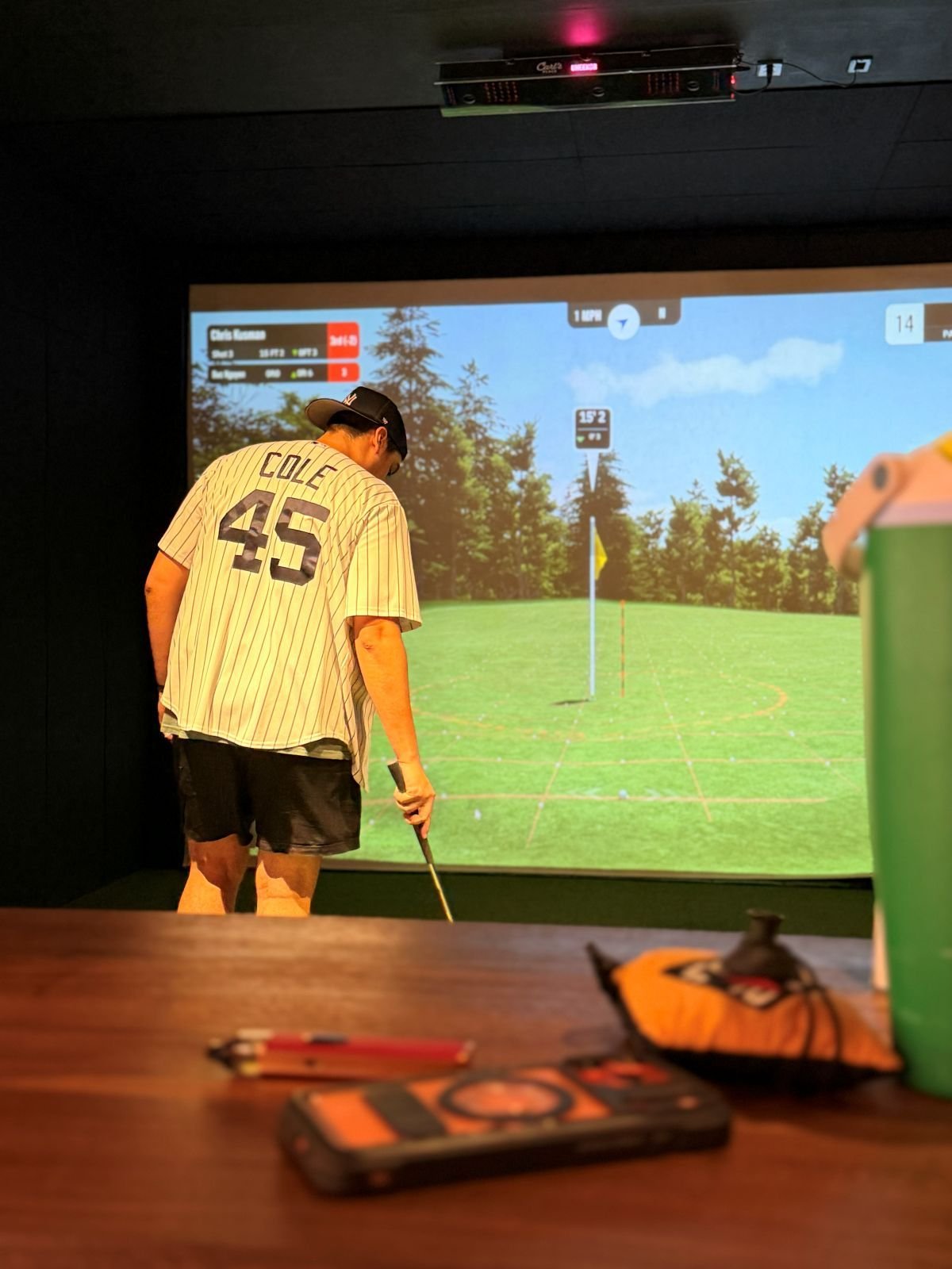 Watching a league tee shot from the high-top table