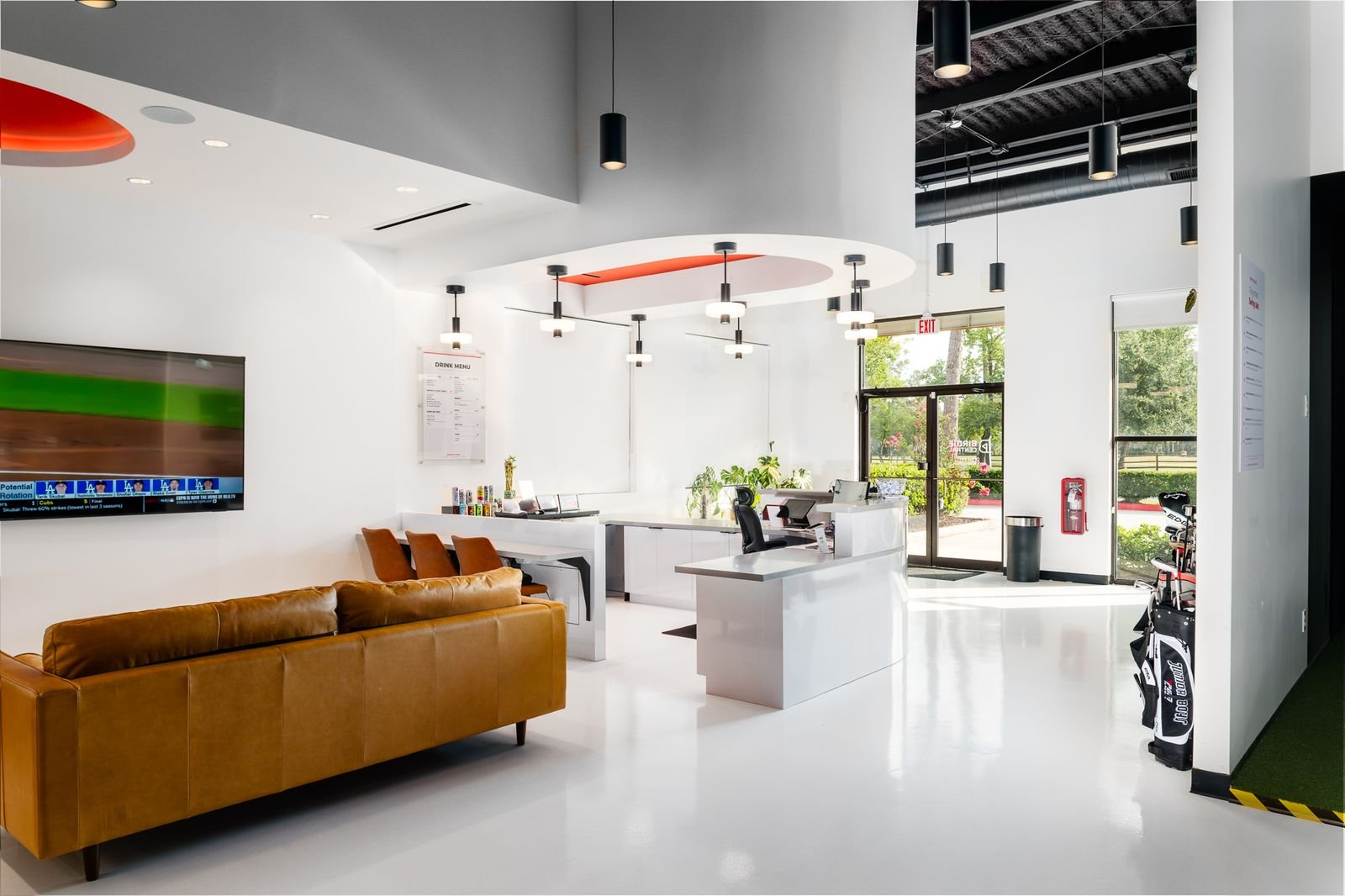 The Birdie Central lounge with leather sofas and simulator bays behind